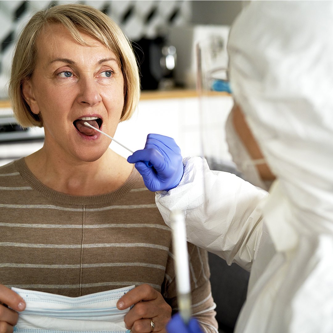 Woman receiving a COVID-19 swab test on her tongue